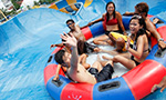 A group of friends playing water rides at Wild Wild Wet water theme park in Singapore